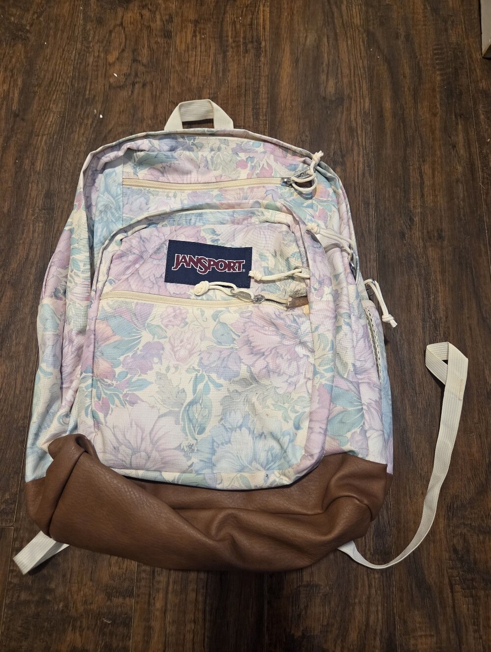 JanSport Cool Student Backpack in the "Faded Tapestry" floral print with a brown